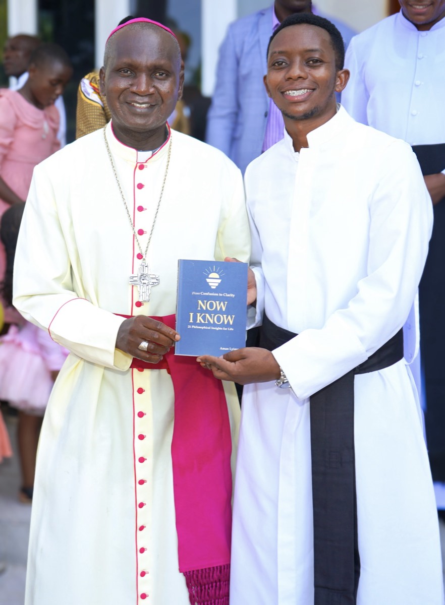 Aman Lyimo in a white cassock handing a copy of Now I Know to a bishop